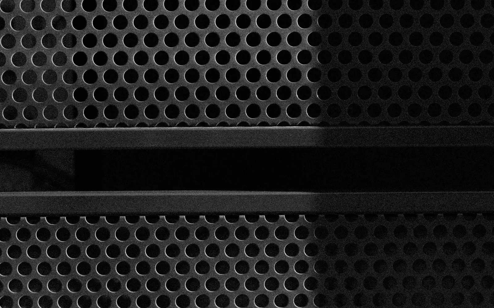 Primer plano de paneles de metal perforado de un equipo de red
